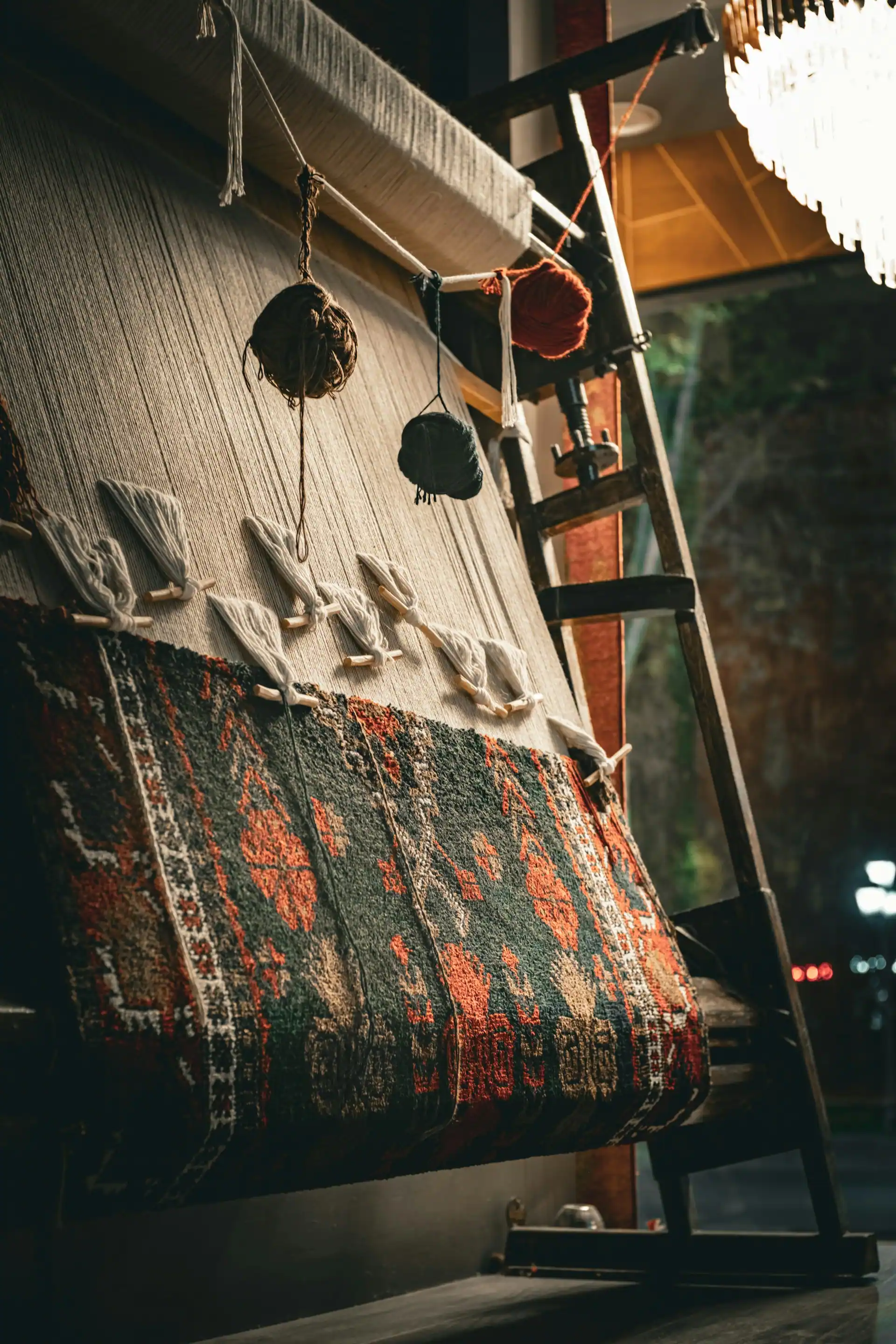 Wide view of the Tuft & Thread studio in Aba, with a hand-tufting frame and wool spools in afternoon light